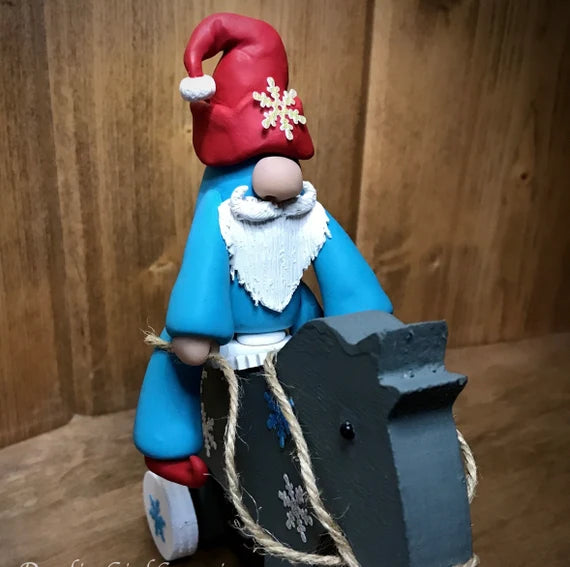 Gnome Elf Riding His Christmas Horse -OOAK Whimsical Blue and Red Clay Figurine Collectible on a Hand Painted Wooden Rolling Horse