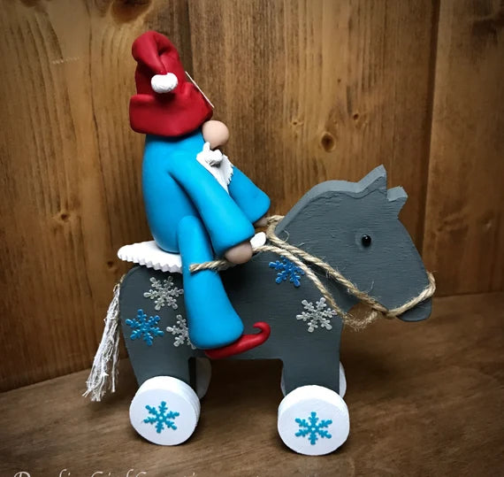 Gnome Elf Riding His Christmas Horse -OOAK Whimsical Blue and Red Clay Figurine Collectible on a Hand Painted Wooden Rolling Horse